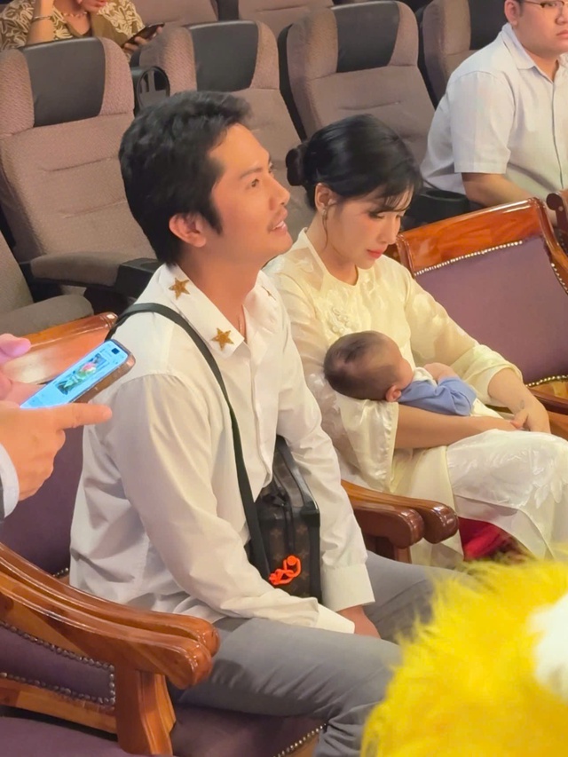 Khả Như bồng bé trẻ sơ sinh bên Huỳnh Phương